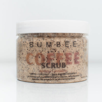 A jar of Bumbee Beauty Coffee Scrub with a white lid. The label reads 'Refresh + Hydrate' and lists the ingredients as coffee, coconut, shea butter, and vitamin E. The text below describes it as an intense natural body scrub designed to tighten, brighten, and diminish the appearance of skin imperfections. The product has a beige color with visible coffee grounds.