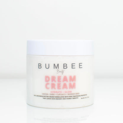 A jar of 'Dream Cream' displayed, featuring natural ingredients and organic butters, designed to moisturize and soften the skin. The image conveys a sense of luxury and hydration, promising nourishment and rejuvenation for the skin